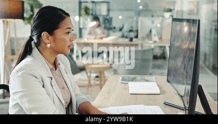 Business, woman and reading on computer at office on internet for research and information as hr manager. Female person, employee and paperwork with Stock Photo