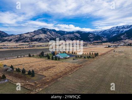 The beautiful Montana landscape, open grassland, fences, dirt road, and clouds. Stock Photo