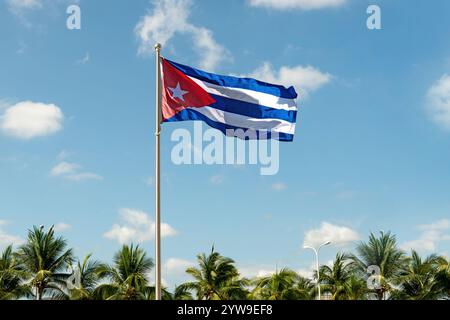Flag on pole against blue sky. Large flag of cuba waving in the wind Stock Photo