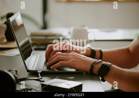 Medium close up of unrecognizable male hand typing on keyboard while programming Stock Photo