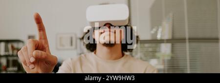 Website banner with man wearing VR and enjoying gaming, he gesticulating frantically Stock Photo
