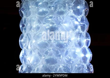 Roll of bubble wrap, plastic waste, close up, dark background,free copy space. Stock Photo