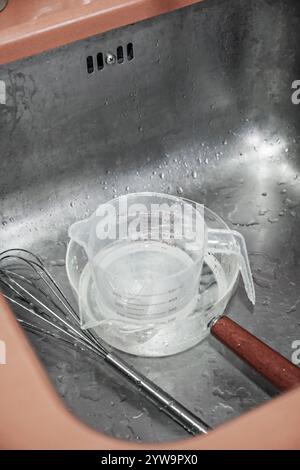 Dirty kitchen utensils inside a kitchen sink Stock Photo