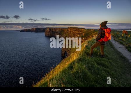 Cliffs of Moher, cliffside hiker, The Burren, County Clare, Ireland, United Kingdom, Europe Stock Photo