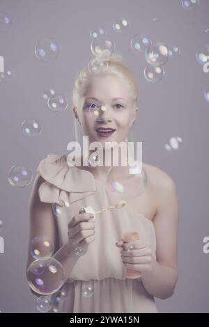 Young, blonde woman with soap bubbles Stock Photo