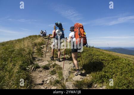 Hikers on the Carynska polonina ridge, Bieszczady National Park, UNESCO Reserve called Eastern Carpathic Biosphere Reserve, Little Poland Voivodeship Stock Photo