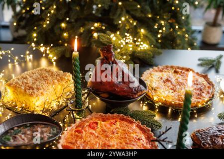 Christmas pork knuckle baked in the oven against the background of a Christmas tree and Christmas. decorations Stock Photo