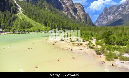 Tourists enjoying summer at lago di landro, also known as durrensee lake, surrounded by the stunning dolomites mountain range in trentino alto adige, Stock Photo