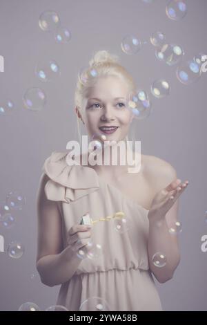 Young, blonde woman with soap bubbles Stock Photo