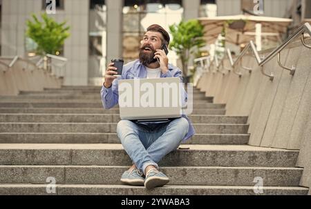 man with freelance communication talk on phone sit on stairs. Stock Photo