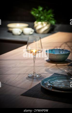 Elegant rose wine glass glowing on a modern kitchen counter, adding a touch of sophistication to the dining table setting Stock Photo