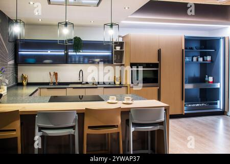 Modern and stylish kitchen showcasing contemporary design and high end appliances, creating a sophisticated culinary space Stock Photo