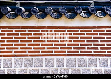 A brick wall with a red brick border. The wall is made of bricks and has a white border Stock Photo