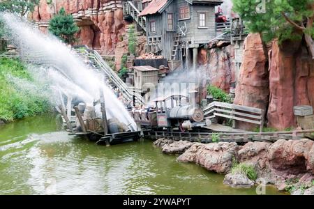 Big Thunder Mountain Railroad, mine train roller coaster  passing through the simulated water splash in Frontierland, Disneyland Paris,  Marne-la-Vallée, France. Stock Photo