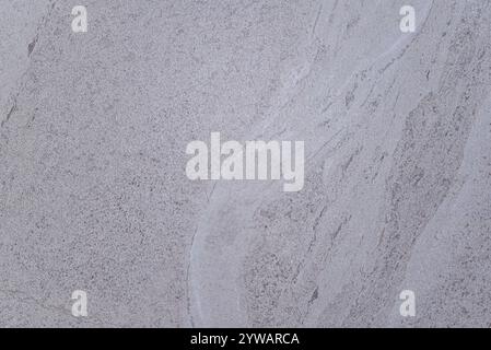 A grey stone wall with a white line. The wall is made of stone and has a white line on it Stock Photo