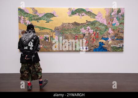 London, England, UK. 10th Dec, 2024. A visitor admires a piece by Takashi Murakami at his new exhibition, Japanese Art History a la Takashi Murakami, on display at Gagosian Grosvenor Hill, London. The exhibition combines AI-generated imagery with hand-painted elements, reinterpreting significant artworks in Japanese art history. (Credit Image: © Thomas Krych/ZUMA Press Wire) EDITORIAL USAGE ONLY! Not for Commercial USAGE! Stock Photo