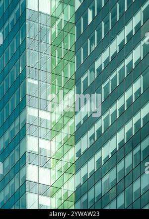 Architectural abstract of facade of modern green glass building with reflections in downtown Edmonton, Alberta Stock Photo