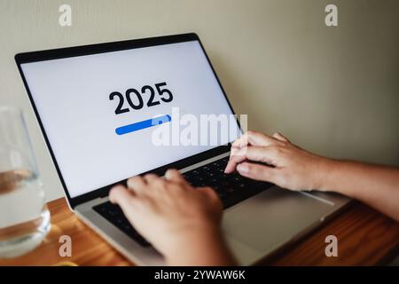 New year, business. Loading icon for 2025 celebration on computer laptop screen Stock Photo