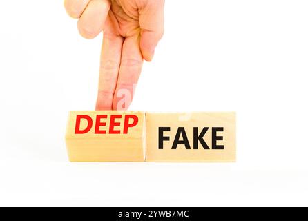 Deepfake or fake symbol. Concept words Fake Deepfake on wooden cubes. Beautiful white table white background. Businessman hand. Business and deepfake Stock Photo