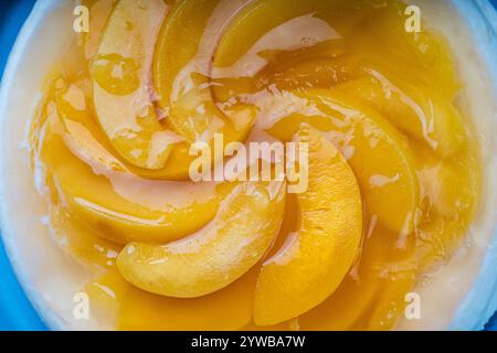 Peach, jelly dessert or cake. Homemade cheesecake with canned peaches on a blue plate. High quality photo Stock Photo