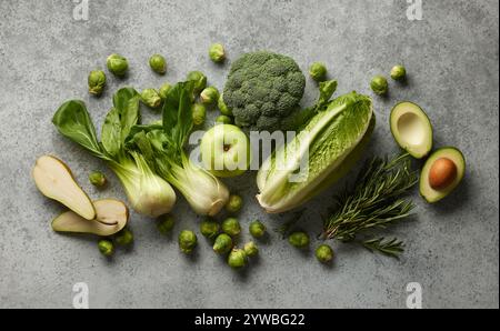 various fresh raw green vegetables on grey table, top view Stock Photo