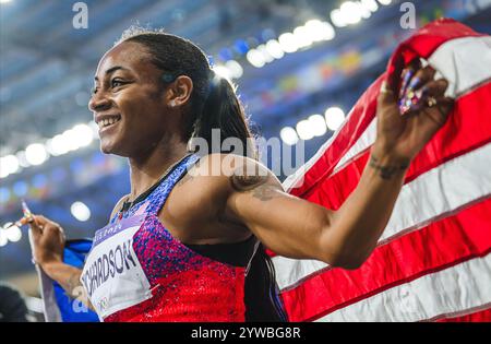 Sha'Carri Richardson celebrating her medal with her country's flag at the Paris 2024 Olympic Games. Stock Photo