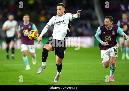 Derby County's Jerry Yates and Burnley's Connor Roberts (right) battle for the ball during the Sky Bet Championship match at Turf Moor, Burnley. Picture date: Tuesday December 10, 2024. Stock Photo