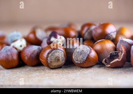A pile of nuts, including almonds, walnuts, and hazelnuts, are spread out on a table Stock Photo