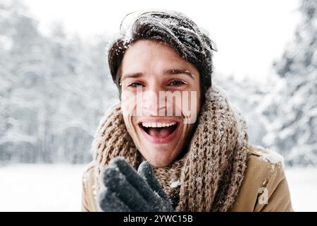 Happy Man Rubbing Hands Smiling Standing In Snowy Forest Stock Photo