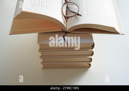 Open blank book on top of stacks of books, Mock up Stock Photo