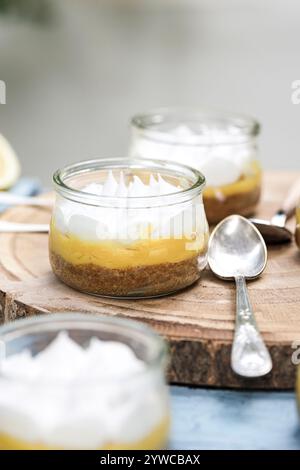 Close-up of individual servings of lemon meringue pies on a wooden chopping board Stock Photo