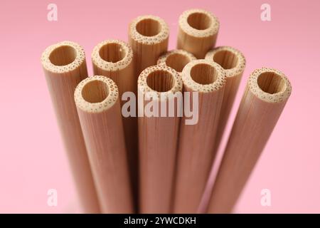 Bamboo drinking straws on pink background, closeup Stock Photo