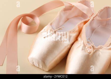 Pair of beautiful pointe shoes on beige background, closeup Stock Photo