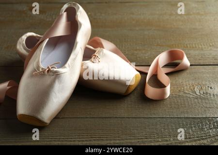 Pair of beautiful pointe shoes on wooden table Stock Photo