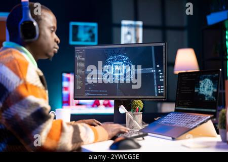African american man working on computer to write code and programming in artificial intelligence and deep learning. Male IT engineer using pc to ensure cyber security, neural network. Stock Photo