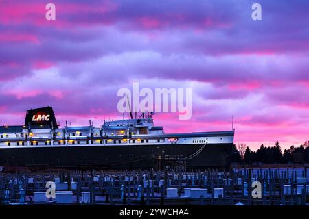 Lake Michigan Carferry's SS Badge in home port for the off-season with background sky filled with dramatic sunset color in Ludington, Michigan, USA. Stock Photo