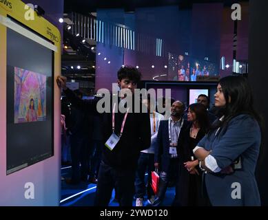 New Delhi, India. 10th Dec, 2024. NEW DELHI, INDIA - DECEMBER 10: A girl click the AI photo during the Amazon Smbhav 2024 on December 10, 2024 in New Delhi, India. (Photo by Sonu Mehta/Hindustan Times/Sipa USA) Credit: Sipa USA/Alamy Live News Stock Photo