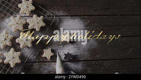 Happy holidays text win gold over snowflake christmas cookies on dark wood Stock Photo
