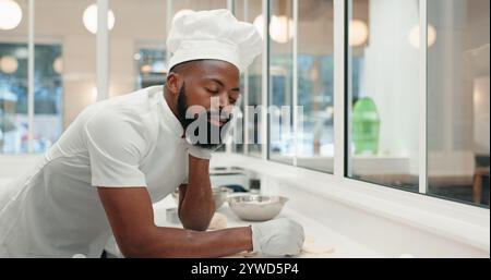 Sleeping, tired and chef with black man in kitchen of coffee shop for overworked, burnout or food industry. Dough, fatigue and cooking with exhausted Stock Photo