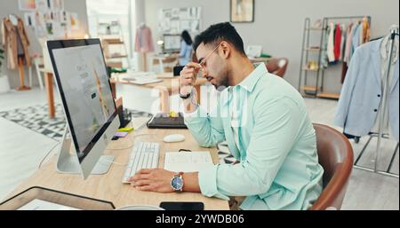 Small business, man and stress on computer as fashion designer with clothes or logistics deadline. Male person, entrepreneur and tired or exhausted Stock Photo