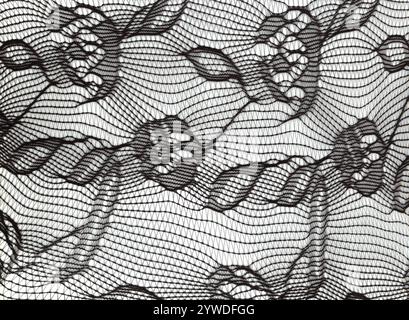 Black nylon flower pattern elasticated micro mesh fabric texture background Stock Photo