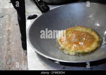 Fried eggs in hot pan. scrambled, Street food stall in thailand. Stock Photo