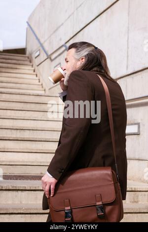 confident male executive manager walking on stairs Stock Photo