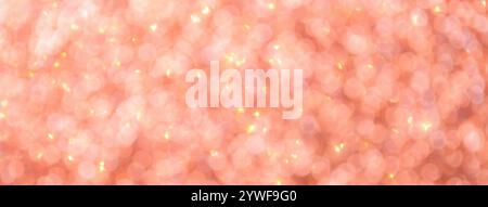 Blurred pink background with circle sparkling lights. Shiny coral glittery bokeh of christmas garland. Dark backdrop Stock Photo