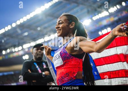 Sha'Carri Richardson celebrating her medal with her country's flag at the Paris 2024 Olympic Games. Stock Photo