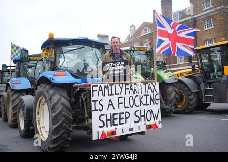 Farmer Will Elliott, 50, of Whipley Manor Farm near Guildford in Surrey, stands on a tractor in Westminster, London, during a protest by farmers over the changes to inheritance tax (IHT) rules in the recent budget with introduce new taxes on farms worth more than £1 million. Picture date: Wednesday December 11, 2024. Stock Photo