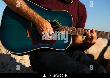 Close-up of a man's hands playing acoustic guitar Stock Photo