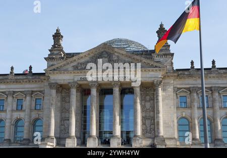 Detailed view of the Reichstag building with the German national flag in the foreground, Reichstag building, German Bundestag, Berlin, Germany, Europe Stock Photo