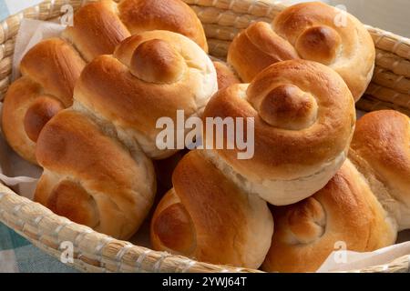 Basket with fresh homemade tasty white buns of bread in a special shape close up Stock Photo