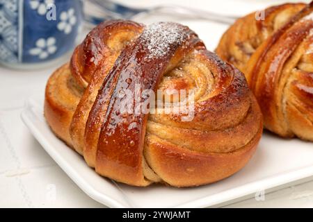 Plate with homemade fresh baked swedish cardamom buns,  Kardemummabullar, close up Stock Photo